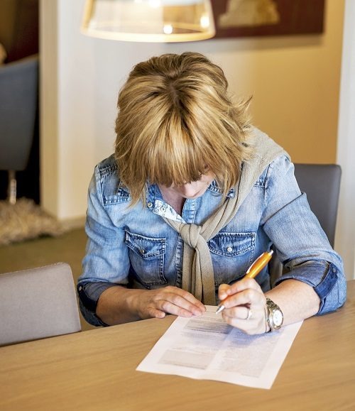 woman filling out benefit claim form