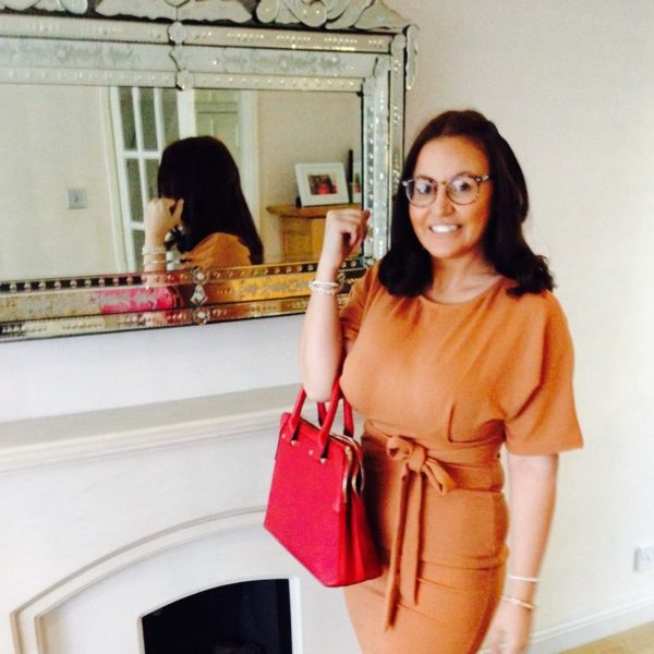 carly holding a red handbag