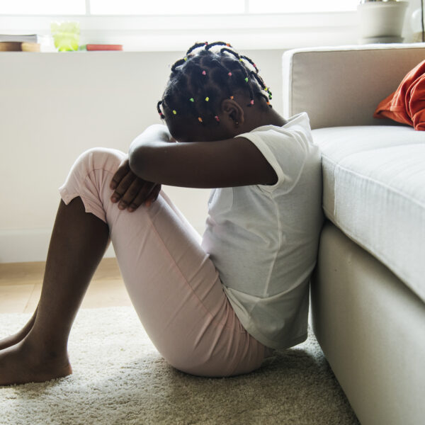 depressed child with head in hands