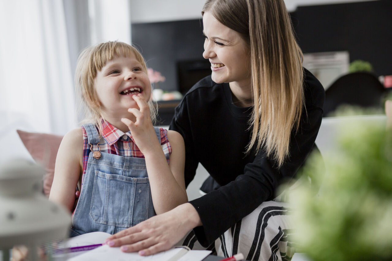 A mother and daughter laughing
